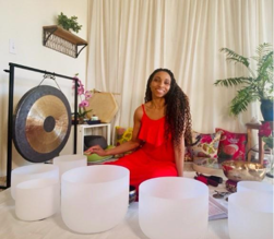 A person sitting in a room with white bowls

Description automatically generated